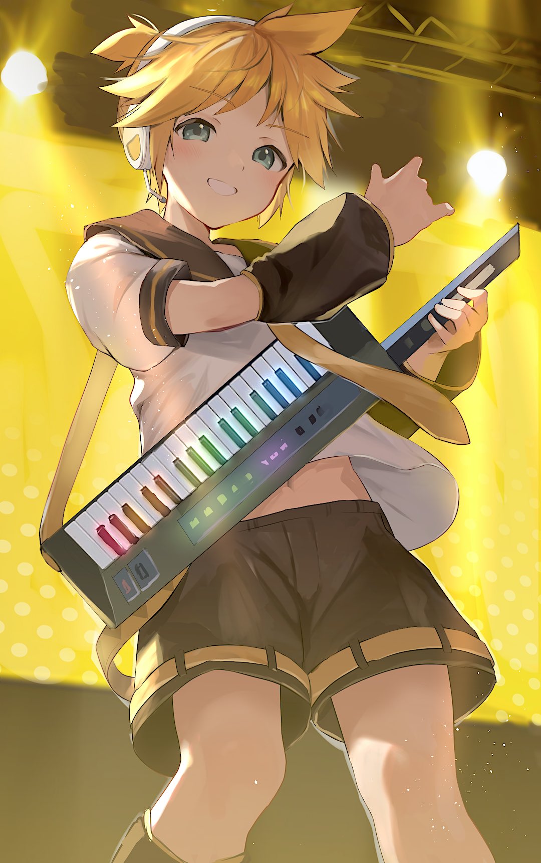 1boy aqua_eyes black_shorts blonde_hair cocolo_(co_co_lo) cowboy from_below headphones highres holding holding_instrument indoors instrument kagamine_len keytar looking_at_viewer male_focus midriff_peek necktie short_ponytail shorts smile solo spotlight standing vocaloid yellow_necktie