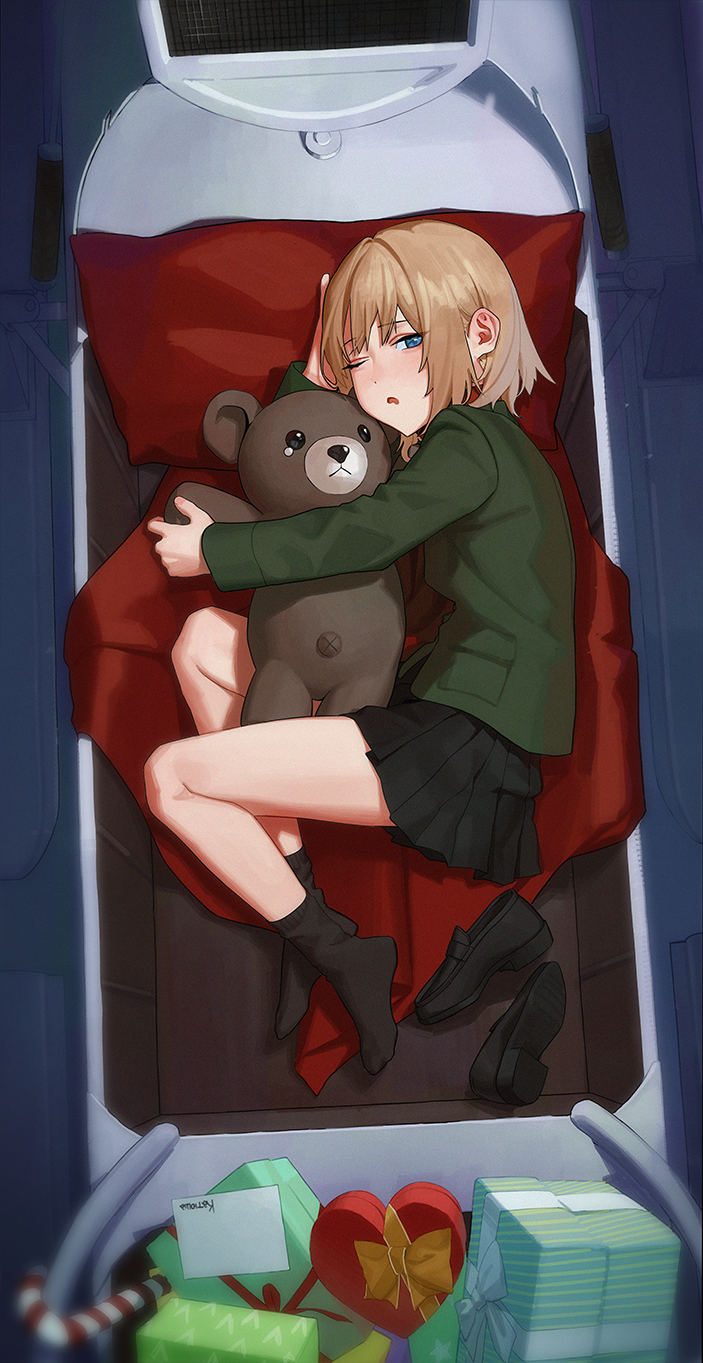 1girl black_footwear black_skirt black_socks blonde_hair blue_eyes box candy candy_cane character_name commentary food from_above fukaumi_suichu full_body gift gift_box girls_und_panzer green_shirt heart-shaped_box highres holding holding_stuffed_toy katyusha_(girls_und_panzer) loafers long_sleeves looking_at_viewer looking_to_the_side lying medium_hair on_side one_eye_closed paper parted_lips pleated_skirt shirt shoes shoes_removed sidelocks skirt socks solo stuffed_animal stuffed_toy teddy_bear