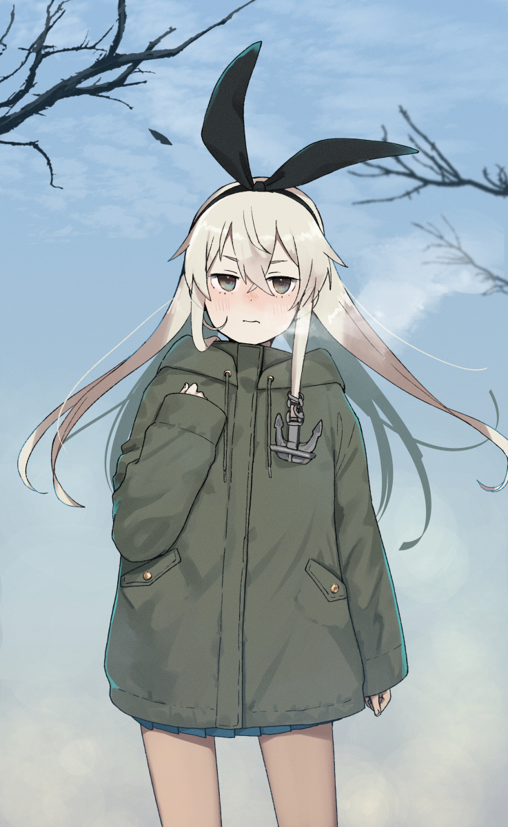 1girl annin_musou bare_tree blonde_hair blue_skirt blush brown_eyes closed_mouth cowboy_shot day green_jacket hair_between_eyes highres jacket kantai_collection long_hair long_sleeves looking_at_viewer miniskirt outdoors pleated_skirt shimakaze_(kancolle) skirt solo straight-on tree winter