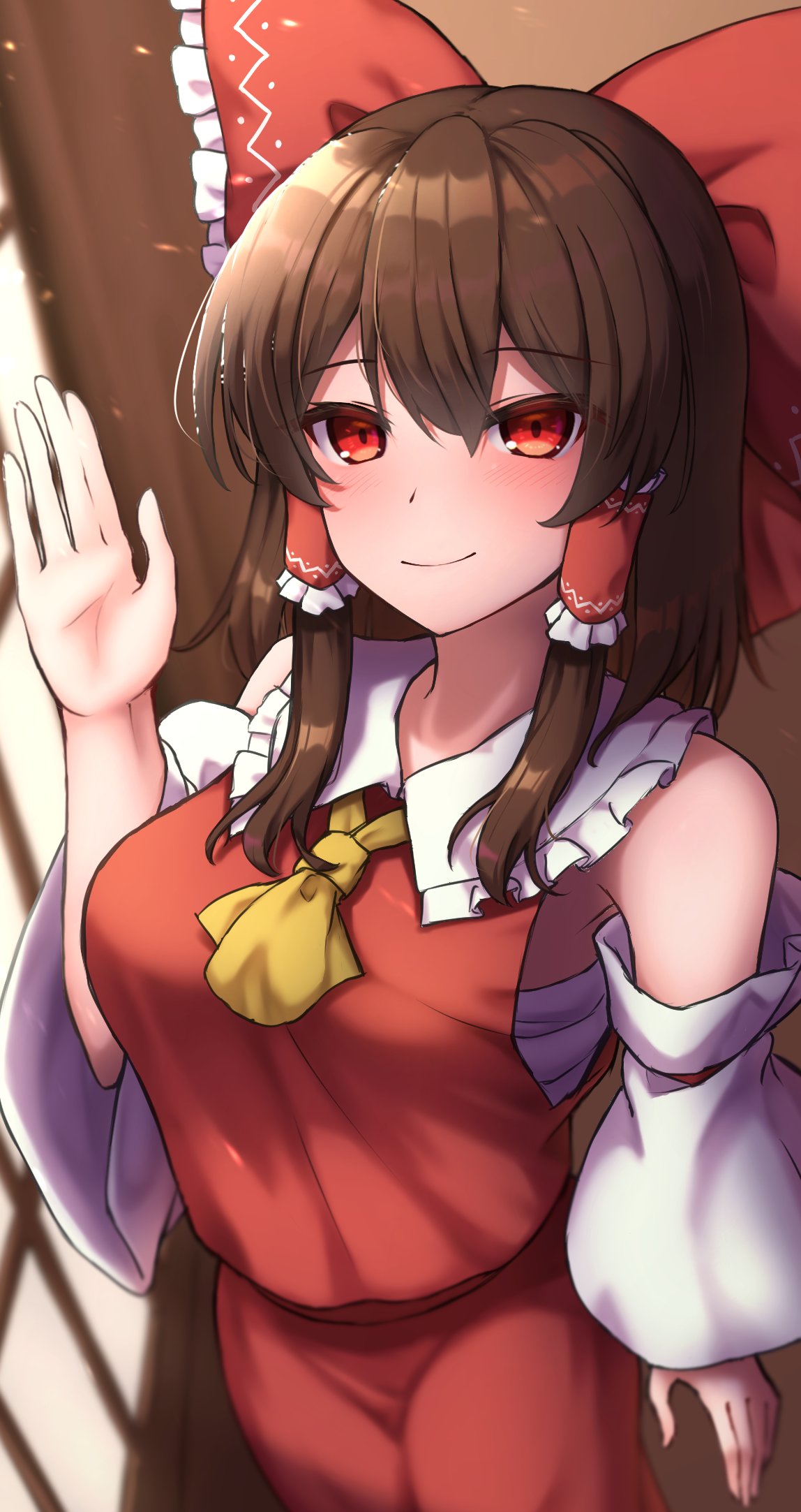 1girl blurry blurry_background blush bow brown_hair closed_mouth commentary_request cowboy_shot detached_sleeves hair_bow hakurei_reimu highres indoors looking_at_viewer medium_hair red_bow red_eyes red_shirt red_skirt shirt skirt smile solo touhou yosshy