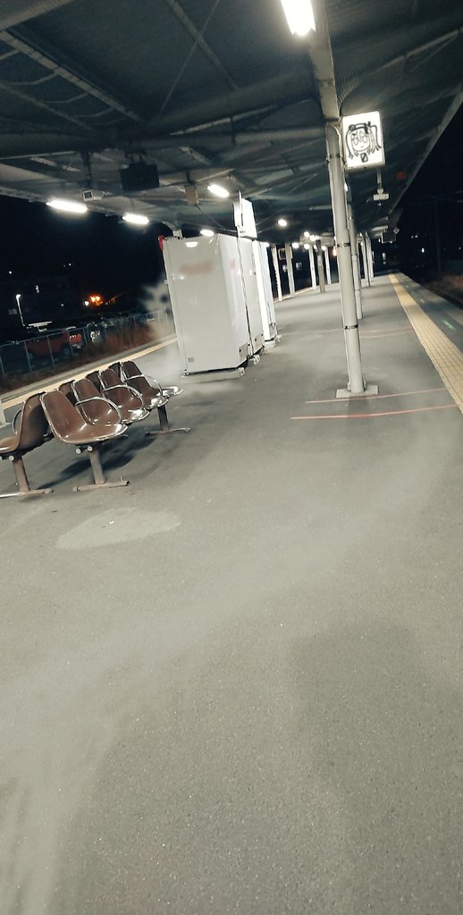 a.i._voice adachi_rei bench canopy_(shelter) co8 commentary_request dutch_angle fluorescent_lamp ghost night no_humans outdoors photo_background shadow sign tactile_paving train_station_platform utau