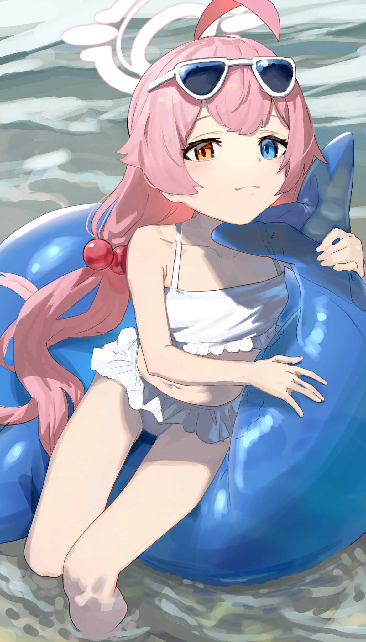 1girl ahoge bikini blue-tinted_eyewear blue_archive blue_eyes closed_mouth eyewear_on_head frilled_bikini frills had_(had314) hair_bobbles hair_ornament heterochromia highres hoshino_(blue_archive) hoshino_(swimsuit)_(blue_archive) inflatable_toy inflatable_whale long_hair looking_at_viewer low_twintails pink_hair solo sunglasses swimsuit tinted_eyewear twintails water white_bikini yellow_eyes