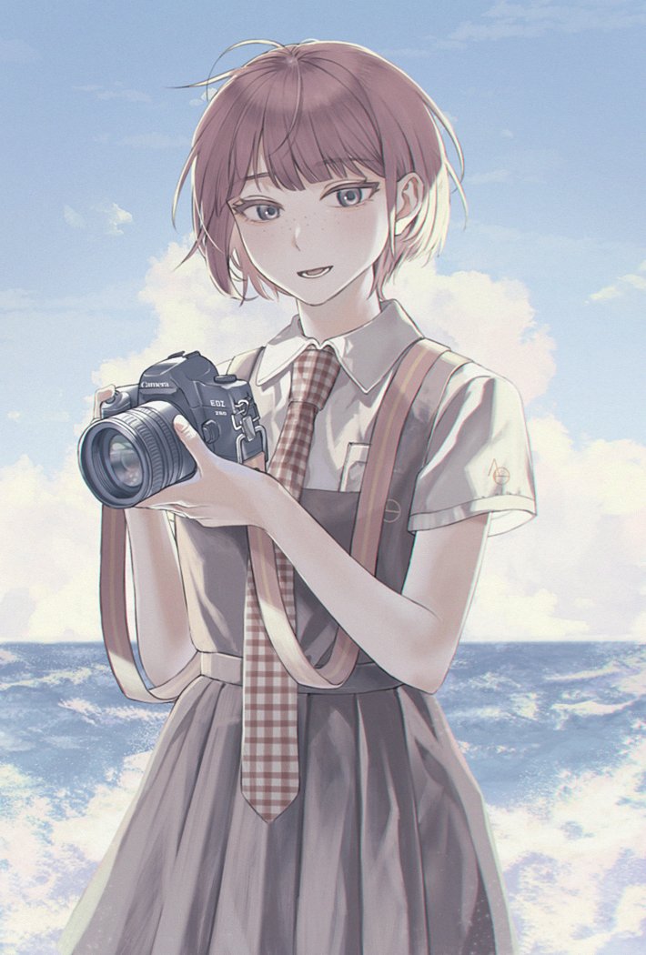 1girl :d birthday blue_sky blunt_bangs blush brand_name_imitation breast_pocket breasts brown_dress brown_eyes camera clouds collared_shirt commentary cowboy_shot cumulonimbus_cloud danganronpa_(series) danganronpa_2:_goodbye_despair day dress dslr eyelashes freckles gingham_necktie holding holding_camera horizon koizumi_mahiru looking_at_viewer loose_hair_strand lower_teeth_only messy_hair necktie ocean open_mouth outdoors parted_lips pinafore_dress pleated_dress pocket red_necktie redhead school_uniform shirt short_hair short_sleeves sky sleeveless sleeveless_dress small_breasts smile solo standing strap taking_picture tanizaki_(tnzk555) teeth waves white_necktie white_shirt wind