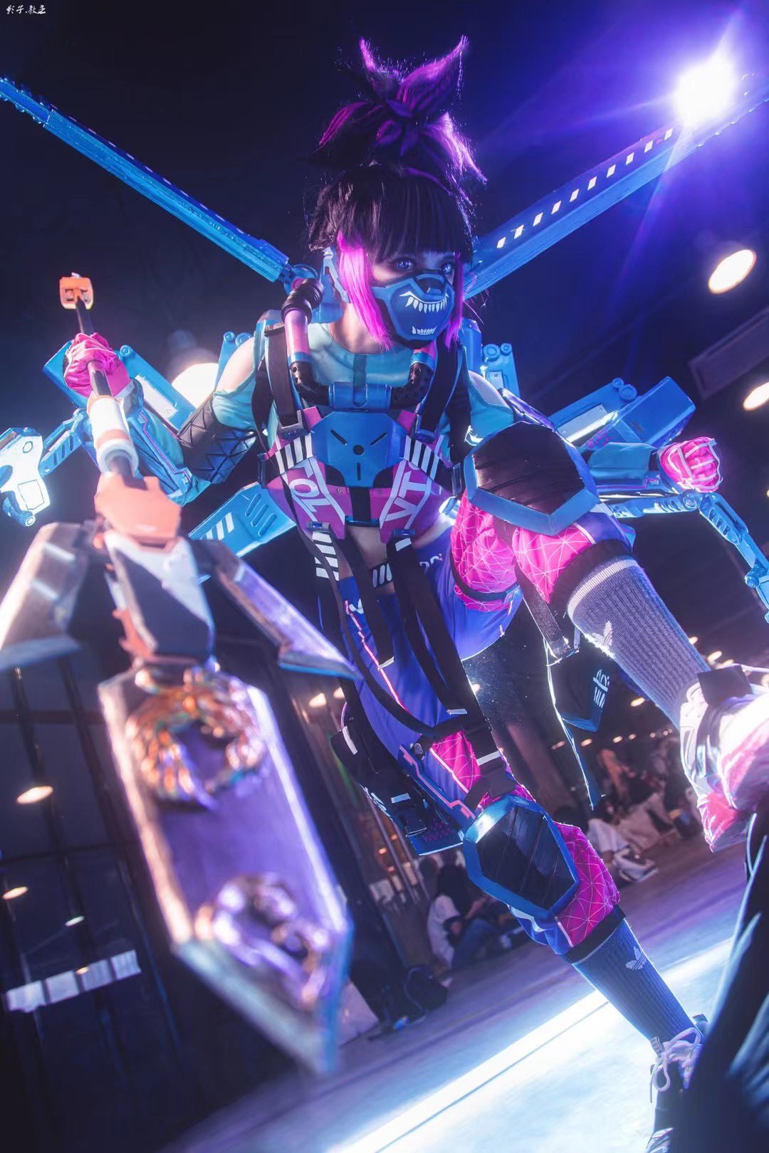 1girl apex_legends armor black_hair blue_shirt breastplate clenched_hand clothing_cutout cosplay_photo di_guan fluorescent_tech_valkyrie gloves grey_socks highres holding holding_polearm holding_weapon knee_pads lance looking_at_viewer mask mouth_mask multicolored_hair photo_(medium) pink_gloves polearm purple_hair shirt shoes shoulder_cutout sneakers socks solo streaked_hair suzaku_(apex_legends) valkyrie_(apex_legends) violet_eyes weapon white_footwear