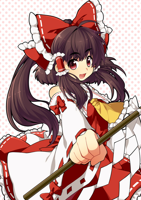 ascot bad_id bow brown_hair clenched_hand detached_sleeves fist foreshortening gohei hair_bow hair_ribbon hair_tubes hakurei_reimu kiri_futoshi open_mouth outstretched_arm polka_dot polka_dot_background ponytail red_eyes ribbon smile solo touhou