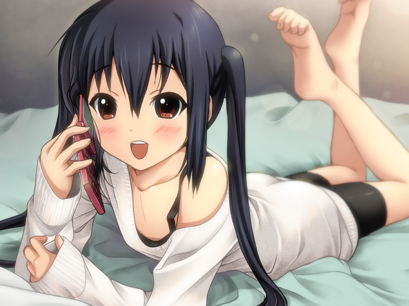 1girl bed bike_shorts black_bike_shorts black_hair blush brown_eyes cellphone feet k-on! long_hair lying nakano_azusa off_shoulder on_stomach phone ryunnu sleeves_past_wrists smile soles solo sweater toe_curl toe_scrunch toes twintails