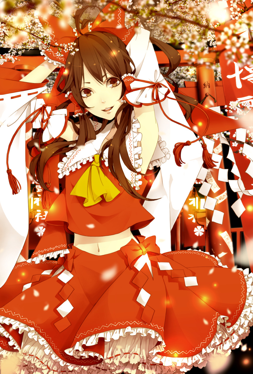 1girl arms_up blurry branch brown_eyes brown_hair depth_of_field detached_sleeves flower frills gohei hakurei_reimu highres light_smile long_hair navel open_clothes open_shirt petals solo torii touhou yugake_(mrnmrm)