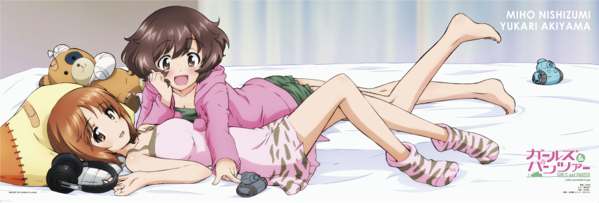 2girls absurdres akiyama_yukari barefoot bed bed_sheet bedroom black_hair blush brown_eyes brown_hair curtains girls_und_panzer headphones highres indoors looking_at_viewer lying military military_vehicle multiple_girls nishizumi_miho official_art on_back on_stomach open_mouth pillow poster room smile socks stuffed_animal stuffed_toy sugimoto_isao tank teddy_bear vehicle