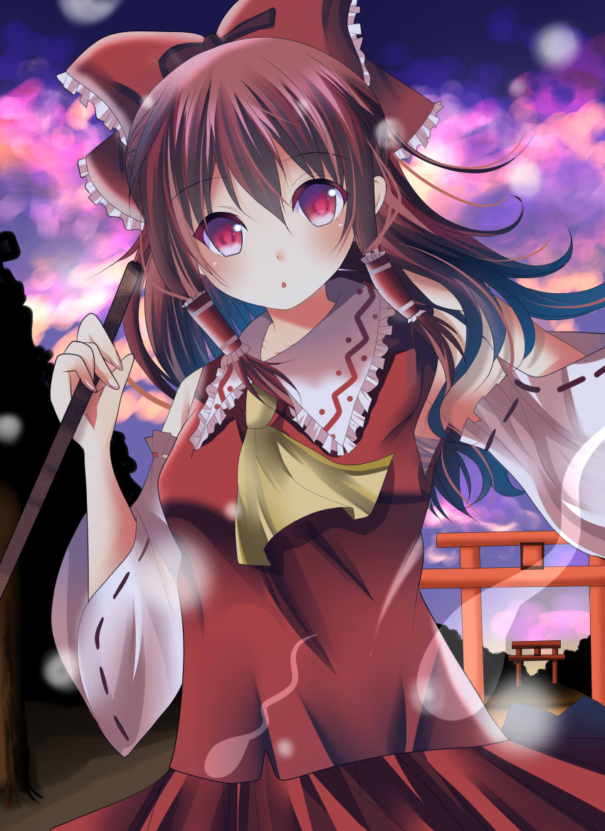 1girl :o absurdres ascot bow brown_hair clouds detached_sleeves gohei hair_bow hair_tubes hakurei_reimu hand_on_own_shoulder head_tilt highres hitodama light_particles long_hair looking_at_viewer outdoors red_eyes skirt skirt_set solo torii twilight umi_no_suzuka wind