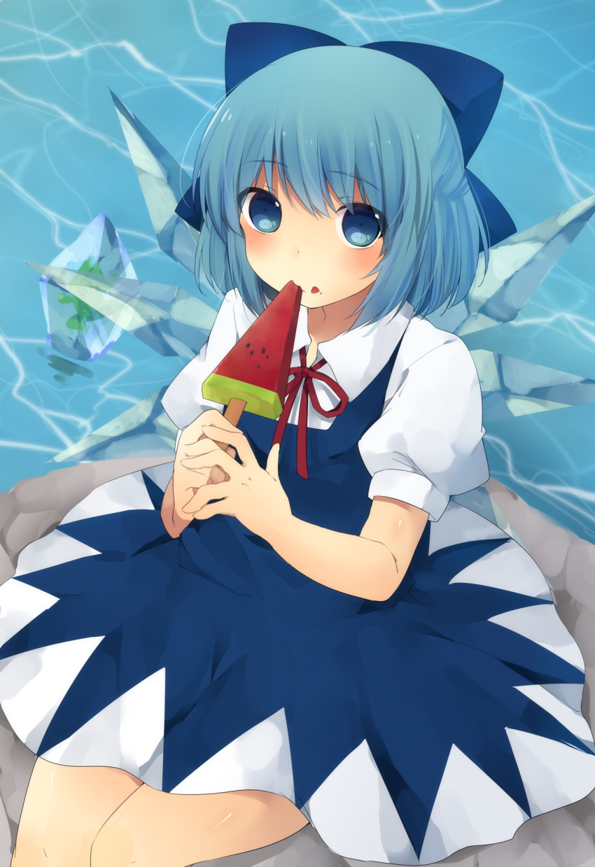 1girl ari_suzushi blue_dress blue_eyes blue_hair cirno dress eating food food_on_face frog frozen hair_bun highres ice ice_wings looking_at_viewer popsicle puffy_sleeves rock shirt short_sleeves sitting_on_rock solo touhou water watermelon_bar wings