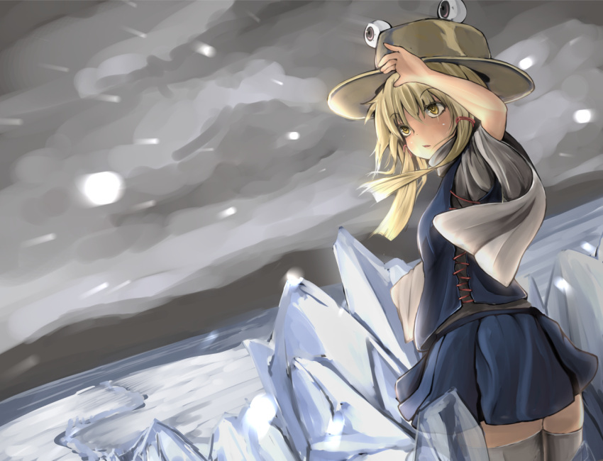 1girl blonde_hair clouds cloudy_sky flanvia hair_ribbon hat looking_at_viewer moriya_suwako ribbon shirt skirt skirt_set sky snow snowing solo thigh-highs touhou vest white_legwear wide_sleeves yellow_eyes zettai_ryouiki