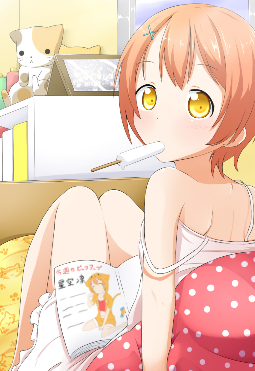 1girl :&lt; back bare_shoulders bed blush book brown_hair dress dripping hair_ornament hairclip highres hoshizora_rin looking_at_viewer looking_back love_live!_school_idol_project makuran mouth_hold official_art pillow popsicle sexually_suggestive sitting sitting_on_bed sleeveless sleeveless_dress solo stuffed_animal stuffed_cat stuffed_toy sundress white_dress yellow_eyes