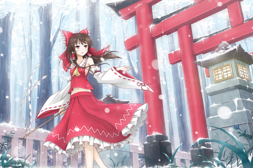 1girl asakurashinji ascot bow brown_eyes brown_hair detached_sleeves gohei hair_bow hair_ribbon hair_tubes hakurei_reimu highres holding looking_at_viewer navel parted_lips ribbon snowing solo stone_lantern torii touhou tree wind