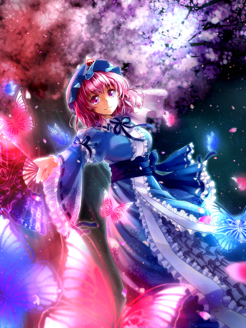 1girl arm_strap blue_dress breasts butterfly cherry_blossoms dress fan floral_print highres juliet_sleeves large_breasts long_sleeves looking_at_viewer mob_cap petals pink_eyes pink_hair puffy_sleeves saigyouji_yuyuko sash shironeko_yuuki smile solo touhou tree triangular_headpiece veil wide_sleeves