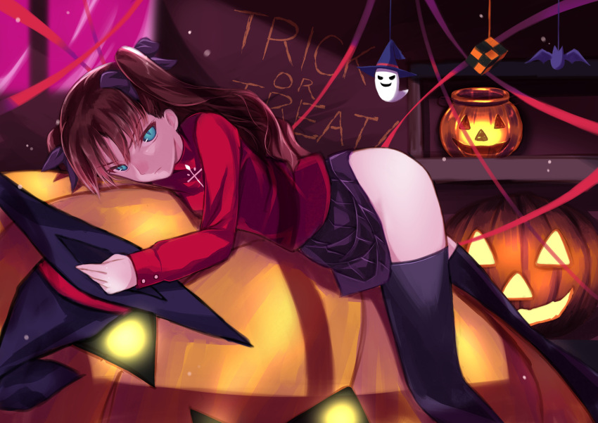 1girl ass black_hair blue_eyes fate/stay_night fate_(series) hair_ribbon halloween hat hat_removed headwear_removed highres jack-o'-lantern kouzuki_hajime long_hair looking_at_viewer lying on_stomach pumpkin ribbon solo thigh-highs tohsaka_rin toosaka_rin two_side_up witch_hat