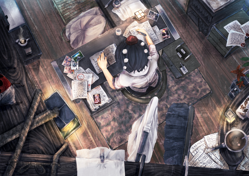 1girl black_hair camera chair desk from_above hat hat_ribbon highres paper pen photo_(object) pillow plant potted_plant puffy_short_sleeves puffy_sleeves ribbon shameimaru_aya shirt short_sleeves sitting skirt solo tokin_hat touhou touro writing