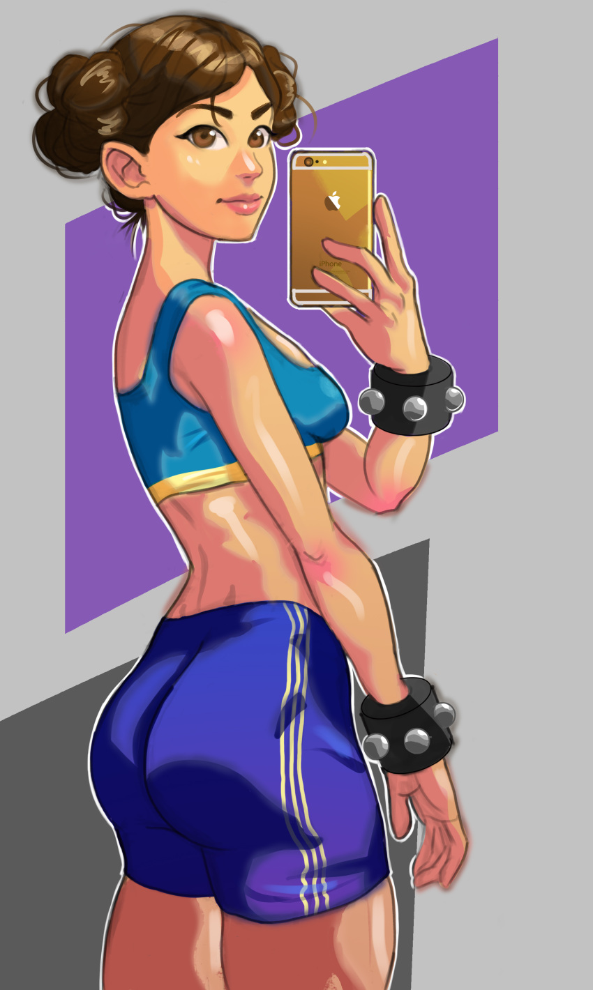 1girl absurdres alternate_hairstyle ass bangs bike_shorts breasts brown_eyes brown_hair cellphone chun-li cowboy_shot double_bun eyebrows from_behind godstime_ojinmah highres lips midriff nose parted_bangs phone self_shot smartphone solo sports_bra street_fighter street_fighter_zero studded_bracelet