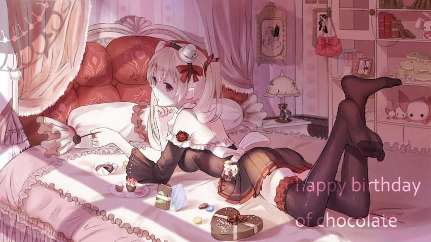1girl back bed black_legwear blonde_hair book chin_rest chocolate chocolate_heart doll doughnut food framed_image hat heart highres lamp legs_up lying mini_hat off_shoulder on_stomach open_mouth original pillow pleated_skirt red_eyes red_flowers skirt solo stuffed_animal stuffed_toy thigh-highs twintails