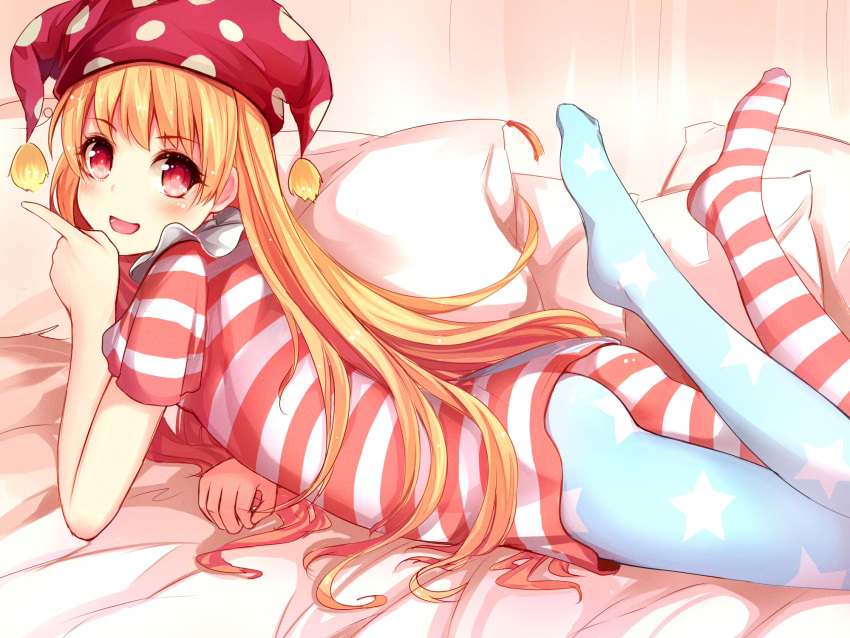 1girl american_flag_legwear american_flag_shirt ass asymmetrical_legwear blonde_hair clownpiece hat highres jester_cap long_hair lying on_bed on_stomach open_mouth pantyhose pillow qunqing red_eyes smile solo touhou