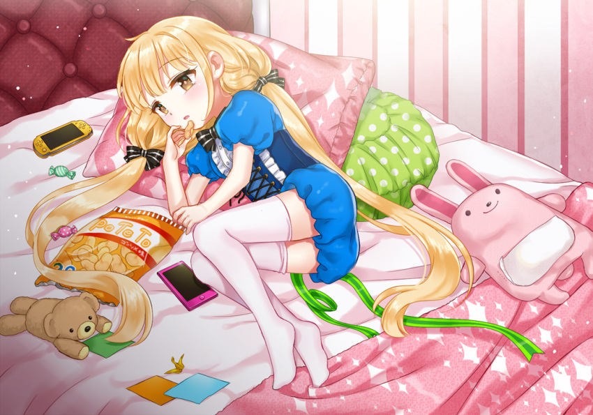 1girl bed blonde_hair brown_eyes chips futaba_anzu handheld_game_console idolmaster idolmaster_cinderella_girls long_hair looking_at_viewer lying naomi_(fantasia) pillow playstation_portable stuffed_animal stuffed_bunny stuffed_toy teddy_bear thigh-highs twintails very_long_hair white_legwear