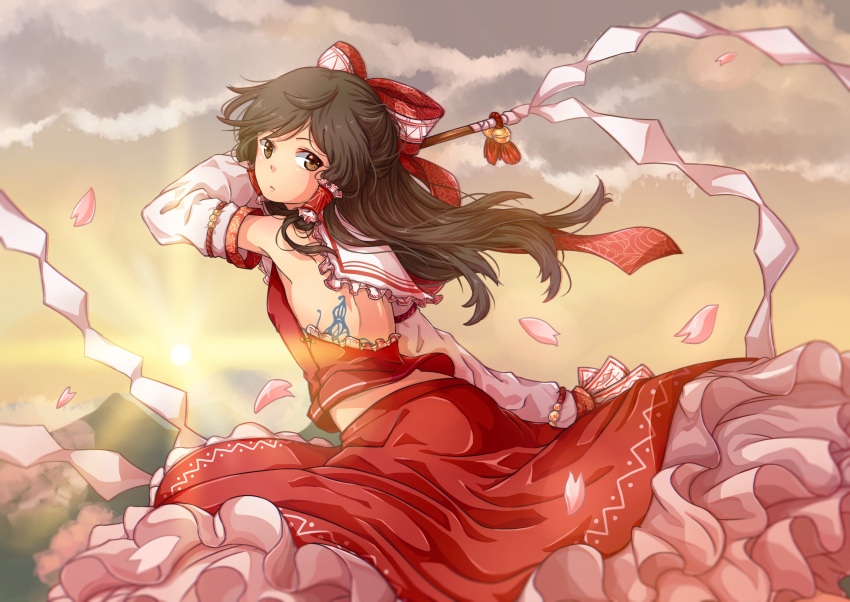 1girl armband back back_tattoo bell bow brown_eyes brown_hair butterfly_tattoo clouds detached_sleeves expressionless flying frilled_collar frilled_shirt frilled_skirt frills gohei hair_bow hakurei_reimu highres light_rays light_trail long_hair looking_at_viewer looking_back midriff mountain petals red_skirt skirt small_breasts solo sun sunburst sunlight suo_niao talismans tattoo touhou wind