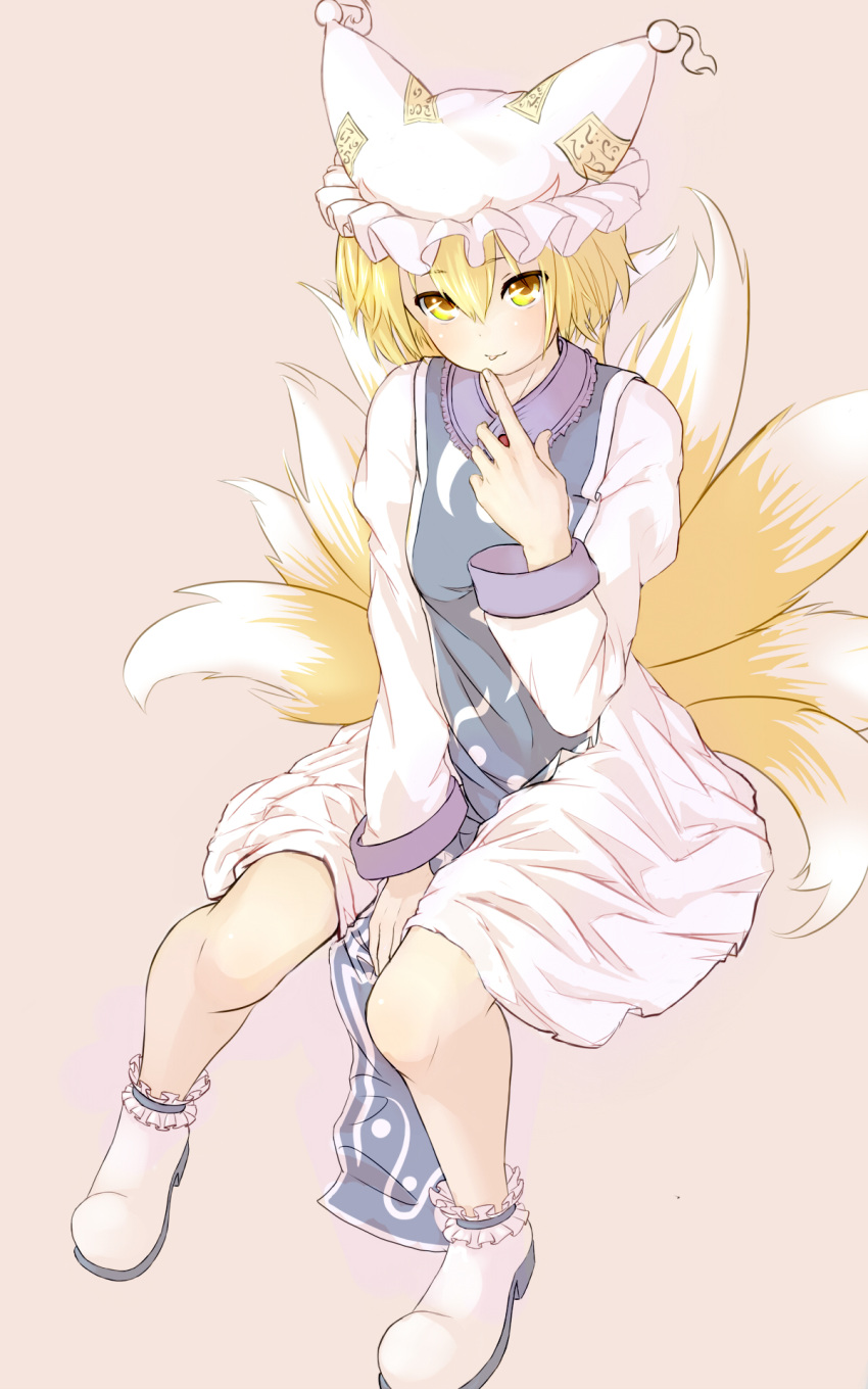 1girl blonde_hair blush breasts dress eyes_visible_through_hair finger_licking fox_tail hand_up hat highres kurosuke_(chatnoir_evil) licking long_sleeves looking_at_viewer multiple_tails no_pupils pillow_hat pink_background saliva saliva_trail shoes short_hair simple_background solo tabard tail touhou white_dress white_shoes yakumo_ran yellow_eyes