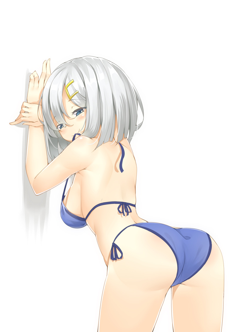 1girl against_wall ass back bikini blue_bikini breasts grey_eyes hair_ornament hairclip hamakaze_(kantai_collection) highres kantai_collection large_breasts leaning_forward looking_at_viewer mouth_hold ootsuki_momiji ribbon_in_mouth side-tie_bikini sideboob silver_hair smile solo swimsuit untied untied_bikini