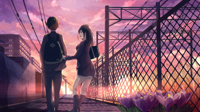 1boy 1girl :d akira_(mr_akira) arm_holding back backpack bag black_hair black_pants black_shoes blazer building chain-link_fence clouds crocus_(flower) fence flower from_behind grass hand_on_another's_arm hands_in_pockets highres jacket kneehighs lens_flare loafers long_hair long_sleeves miniskirt open_mouth original outdoors pants pleated_skirt power_lines purple_flower school_bag school_uniform shade shadow shoes shoulder_bag skirt sky smile sunset utility_pole_(object) vocaloid walking wall