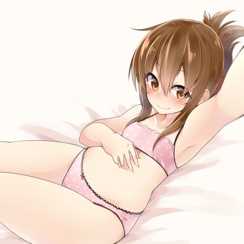 1girl armpits blush bow bow_panties brown_eyes brown_hair camisole commentary folded_ponytail hand_on_own_stomach highres inazuma_(kantai_collection) kantai_collection looking_at_viewer makiya_1919 on_bed panties pink_panties polka_dot polka_dot_panties self_shot smile solo underwear underwear_only wavy_mouth