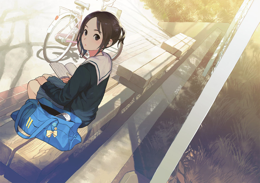 1girl bag bench bicycle black_blouse black_eyes black_serafuku book brown_hair commentary_request day evening grass ground_vehicle handheld_game_console holding holding_book long_sleeves looking_at_viewer looking_back messenger_bag morifumi open_book original outdoors playstation_portable pleated_skirt sailor_collar school_uniform serafuku shadow shoulder_bag sitting skirt solo