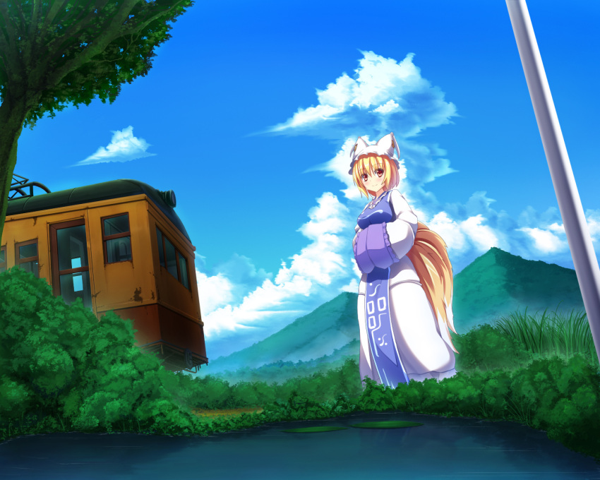 1girl animal_ears blonde_hair blue_sky blush clouds fox_ears fox_tail grass ground_vehicle hands_in_sleeves hat highres liya long_sleeves mountain multiple_tails outdoors pillow_hat scenery short_hair sky solo tabard tail tassel touhou train tree wide_sleeves yakumo_ran yellow_eyes