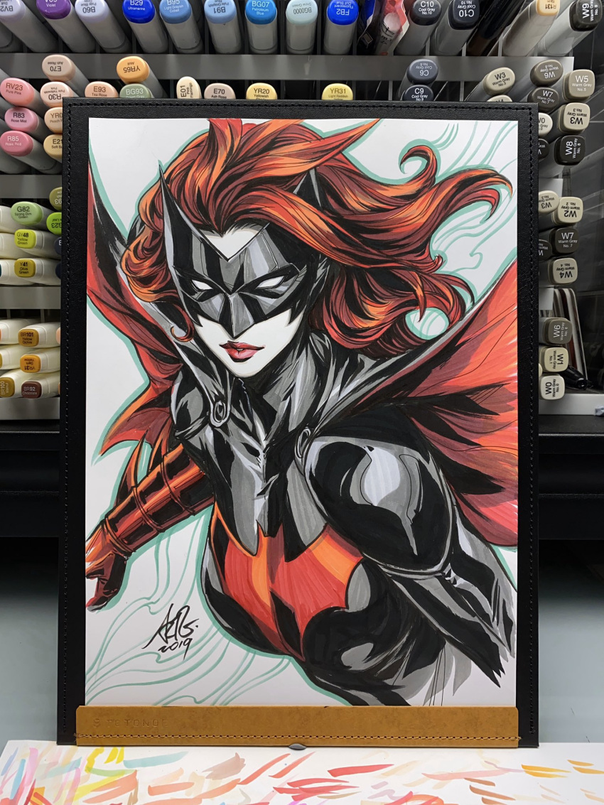1girl 2019 batman_symbol batwoman black_bodysuit black_cape black_mask bodysuit cape commentary english_commentary gloves highres inktober long_hair marker_(medium) mask multicolored_bodysuit photo_(medium) red_cape red_gloves red_hair red_lips signature simple_background solo stanley_lau superhero_costume traditional_media two-tone_bodysuit upper_body