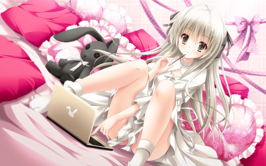 1girl antenna_hair bed_sheet black_ribbon brown_eyes computer dress dutch_angle eyebrows_visible_through_hair floating_hair hair_ribbon heart heart_pillow highres index_finger_raised kasugano_sora long_hair pillow ribbon silver_hair sitting socks solo suzui_narumi white_dress white_legwear white_ribbon yosuga_no_sora