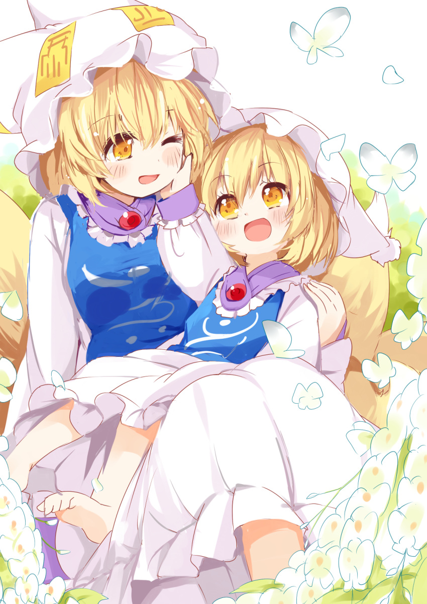 2girls barefoot blonde_hair blush butterfly dress dual_persona eye_contact flower fox_tail hand_on_another's_face hat highres japa long_sleeves looking_at_another mob_cap multiple_girls multiple_tails one_eye_closed open_mouth orange_eyes pillow_hat short_hair sitting tabard tail touhou white_dress yakumo_ran younger