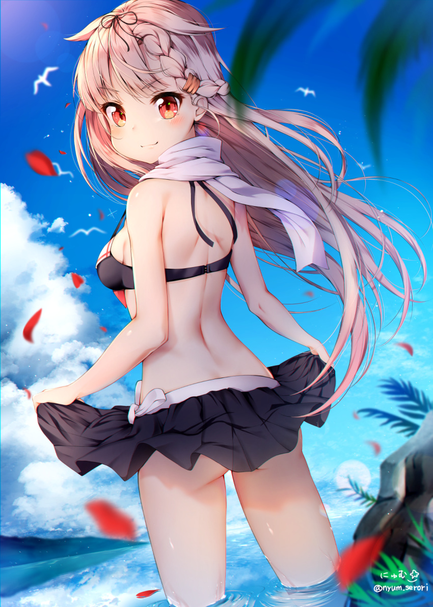 1girl back bangs bikini bird black_bikini black_ribbon black_skirt blonde_hair blue_sky day from_behind hair_ribbon highres kantai_collection lifted_by_self long_hair looking_at_viewer looking_back nyum outdoors palm_tree red_eyes ribbon scarf seagull skirt skirt_lift sky smile solo standing summer swimsuit tree twitter_username wading water white_scarf yuudachi_(kantai_collection)
