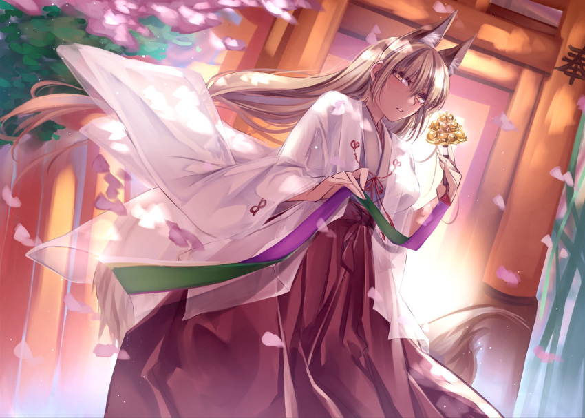 1girl animal_ears bangs bell cherry_blossoms cowboy_shot dappled_sunlight day fox_ears fox_girl fox_tail hakama haori highres japanese_clothes jingle_bell light_brown_hair long_hair long_sleeves looking_at_viewer miko original parted_lips petals solo sunlight tail torii wide_sleeves yellow_eyes yukibuster