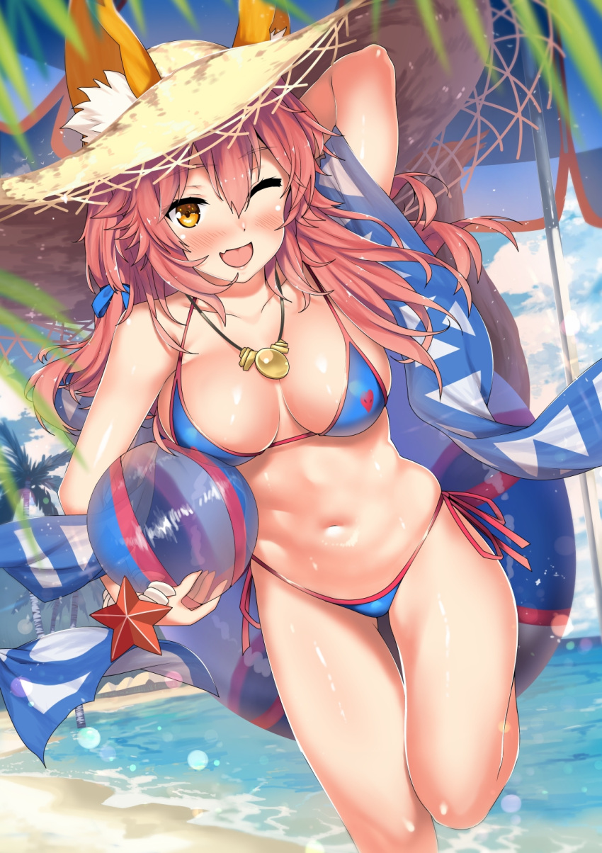 1girl ;d animal_ears ball bangs beach beachball bikini blue_bikini blue_sky blush breasts brown_eyes clouds cloudy_sky day eyebrows_visible_through_hair fang fate/grand_order fate_(series) fox_ears hair_between_eyes hat highres holding holding_ball innertube kawai long_hair medium_breasts navel ocean one_eye_closed open_mouth outdoors pink_hair sky smile solo straw_hat swimsuit tamamo_(fate)_(all) tamamo_no_mae_(swimsuit_lancer)_(fate) thighs wavy_hair