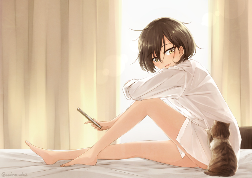 1girl :d animal backlighting bangs bare_legs barefoot bed bed_sheet blush bottomless brown_hair cat cellphone commentary curtains day eyebrows_visible_through_hair full_body holding holding_phone indoors knee_up leaning_forward legs long_sleeves looking_down looking_to_the_side naked_shirt no_pants on_bed open_mouth original phone shirt short_hair smartphone smile solo sunlight twitter_username umino_mokuzu_(shizumisou) white_shirt