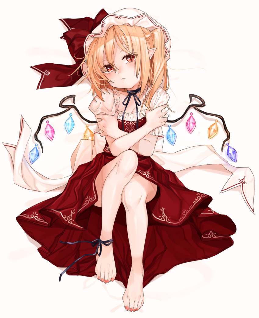 1girl ankle_ribbon bare_legs barefoot black_ribbon blonde_hair feet flandre_scarlet full_body gotoh510 hat hat_ribbon highres looking_at_viewer nail_polish neck_ribbon pointy_ears puffy_short_sleeves puffy_sleeves red_eyes red_nails red_ribbon red_skirt ribbon short_sleeves simple_background sitting skirt solo toes touhou white_background wings