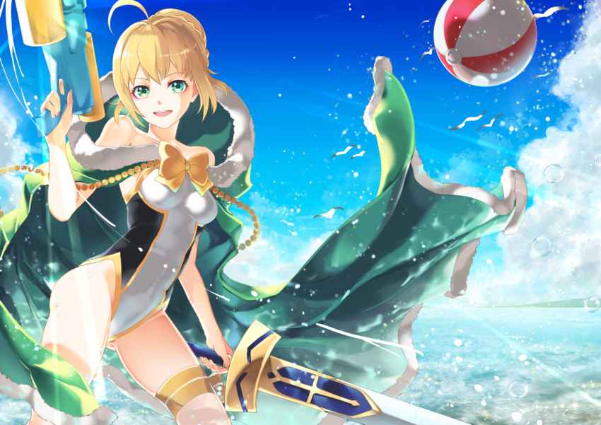1girl ahoge annojou_haruto ball beachball blonde_hair cape clouds competition_swimsuit excalibur fate/grand_order fate/stay_night fate_(series) fur-trimmed_cape fur_trim green_eyes hair_bun one-piece_swimsuit saber solo swimsuit sword water water_gun weapon