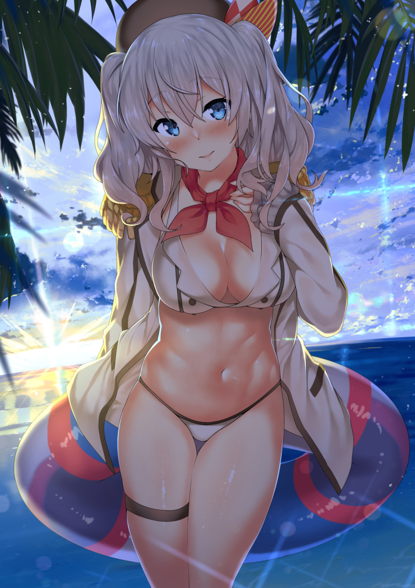 1girl beach beret bikini blue_eyes breasts cleavage clouds day epaulettes frilled_sleeves frills hat highres innertube kantai_collection kashima_(kantai_collection) kawai kerchief large_breasts long_hair long_sleeves looking_at_viewer military military_uniform navel ocean open_clothes outdoors palm_tree sidelocks silver_hair sky solo standing sunset swimsuit thigh_strap tree tsurime twintails uniform water wavy_hair white_bikini