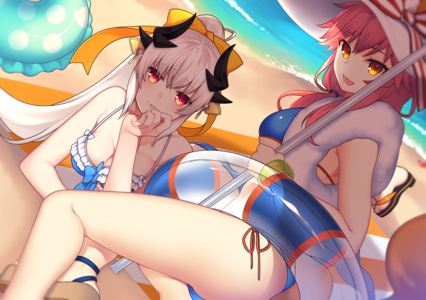 2girls :3 :d beach bikini blue_bikini bow bracelet breasts chin_rest cleavage dutch_angle fate/grand_order fate_(series) hair_bow horns innertube jewelry kiyohime_(fate/grand_order) lio_(tsukuyomi-tei) long_hair looking_at_viewer lying medium_breasts multiple_girls open_mouth orange_eyes outdoors parted_lips pink_hair ponytail red_eyes side-tie_bikini sitting smile smirk swimsuit tail tamamo_(fate)_(all) tamamo_no_mae_(swimsuit_lancer)_(fate) white_hair yokozuwari