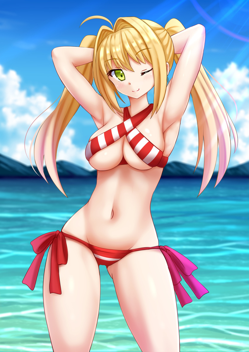 1girl ;) ahoge armpits arms_behind_head bikini blonde_hair blue_sky breasts clouds cowboy_shot criss-cross_halter day fate/grand_order fate_(series) green_eyes groin hair_intakes halterneck highres kazenokaze large_breasts light_rays long_hair looking_at_viewer navel nero_claudius_(swimsuit_caster)_(fate) one_eye_closed outdoors red_bikini saber_extra sky smile solo striped striped_bikini sunbeam sunlight swimsuit twintails water
