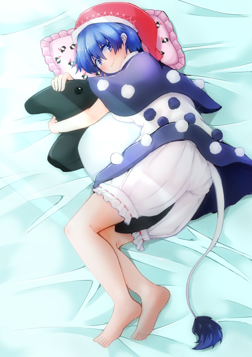 1girl baku_(creature) bangs barefoot bed_sheet between_legs bloomers blue_eyes blue_hair blush capelet closed_mouth doremy_sweet eyebrows_visible_through_hair from_side full_body hair_between_eyes hat hex_aaaane highres looking_at_viewer lying nightcap on_side pillow pom_pom_(clothes) short_hair smile solo stuffed_animal stuffed_toy tail touhou underwear