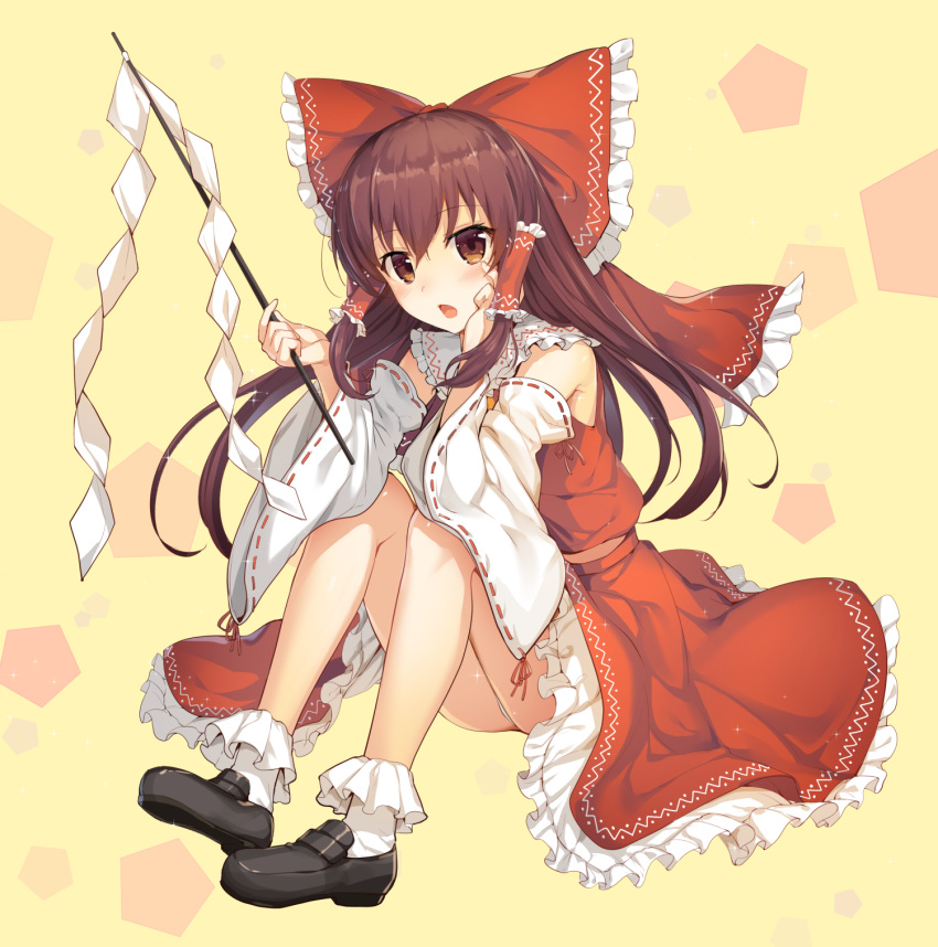1girl bangs bare_legs black_shoes bobby_socks bow brown_eyes brown_hair commentary_request detached_sleeves frilled_skirt frills full_body gohei hair_bow hair_tubes hakurei_reimu highres holding ikomochi long_hair looking_at_viewer panties pantyshot pantyshot_(sitting) red_bow red_skirt ribbon-trimmed_sleeves ribbon_trim shide shoes sidelocks sitting skirt skirt_set socks solo touhou underwear vest white_legwear yellow_background