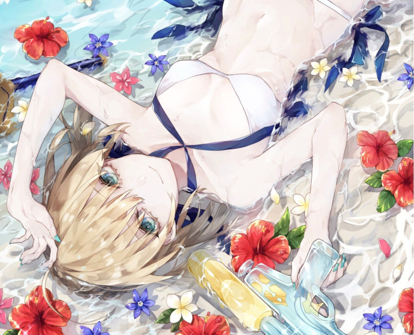 1girl arm_up artoria_pendragon_(all) artoria_pendragon_(swimsuit_archer) bikini blonde_hair blue_flower blue_ribbon breasts cleavage day excalibur eyebrows_visible_through_hair fate/grand_order fate_(series) flower from_above green_eyes green_nails gun hair_between_eyes halterneck hibiscus holding holding_gun holding_weapon looking_at_viewer lying medium_breasts mirage_papillon nail_polish on_back outdoors red_flower ribbon saber short_hair smile solo swimsuit water water_gun weapon white_bikini white_flower