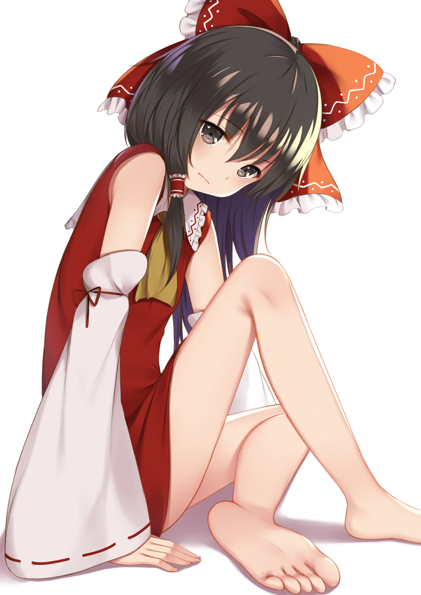 1girl ascot barefoot black_eyes black_hair bow commentary detached_sleeves dress feet flan_(seeyouflan) frilled_bow frills frown hair_between_eyes hair_bow hair_tubes hakurei_reimu highres looking_at_viewer red_dress ribbon-trimmed_sleeves ribbon_trim simple_background sitting soles solo toes touhou white_background wide_sleeves yellow_neckwear