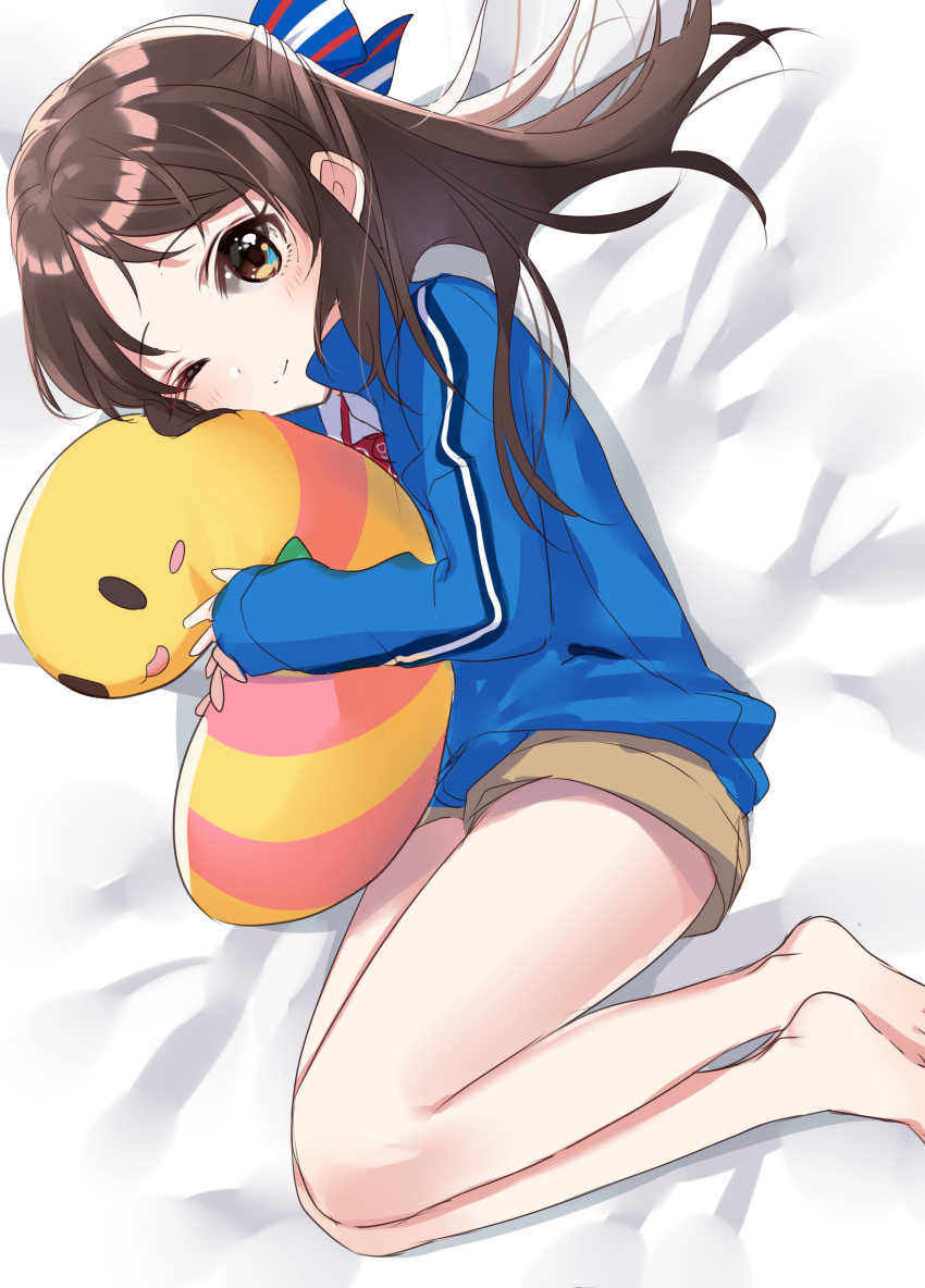 1girl absurdres bangs bare_legs barefoot bed_sheet blue_bow blush bow brown_eyes brown_hair brown_shorts closed_mouth hair_bow half_updo highres idolmaster idolmaster_cinderella_girls jacket lying object_hug on_side one_eye_closed open_clothes open_jacket short_shorts shorts sidelocks sinsihukunokonaka smile solo striped striped_bow stuffed_animal stuffed_toy tachibana_arisu