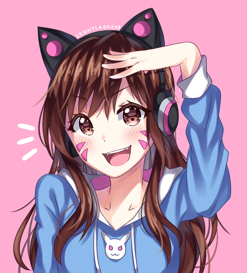 1girl absurdres animal_print arm_up artist_name blue_hoodie blush brown_eyes brown_hair bunny_print casual cat_ear_headphones collarbone commentary d.va_(overwatch) facepaint facial_mark fangs headphones helen_phan highres long_sleeves looking_at_viewer open_mouth overwatch pink_background salute sidelocks signature simple_background smile solo upper_body whisker_markings