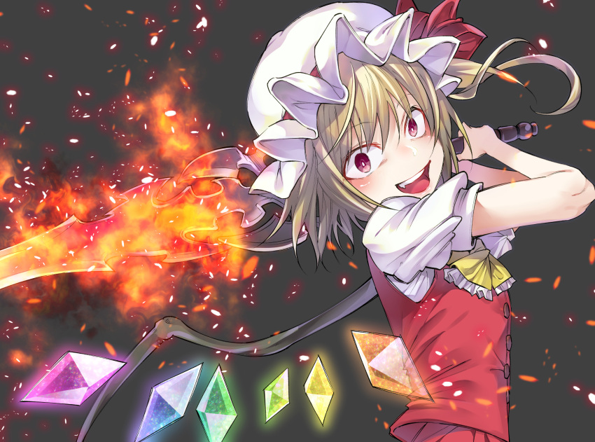 1girl ascot bangs blonde_hair commentary_request fang fire flandre_scarlet grey_background hands_up hat hat_ribbon highres holding holding_sword holding_weapon laevatein long_hair looking_at_viewer mob_cap open_mouth red_eyes red_ribbon ribbon shiori_(moechin) short_sleeves simple_background smile solo sword teeth touhou upper_body vest weapon white_hat wings yellow_neckwear